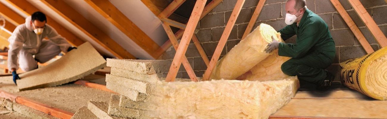 Men laying down loft insulation