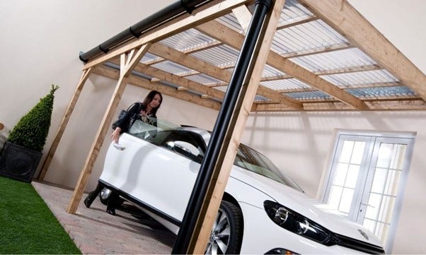 a woman and white car under a car port covered with pvc roof sheets